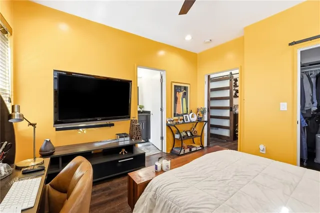 a bedroom with a bed and a flat screen tv