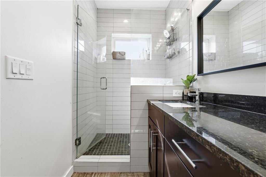 225 Crumley Street Southwest Atlanta, GA 30312 - Photo 19 of 23 a bathroom with a sink a granite counter and a mirror