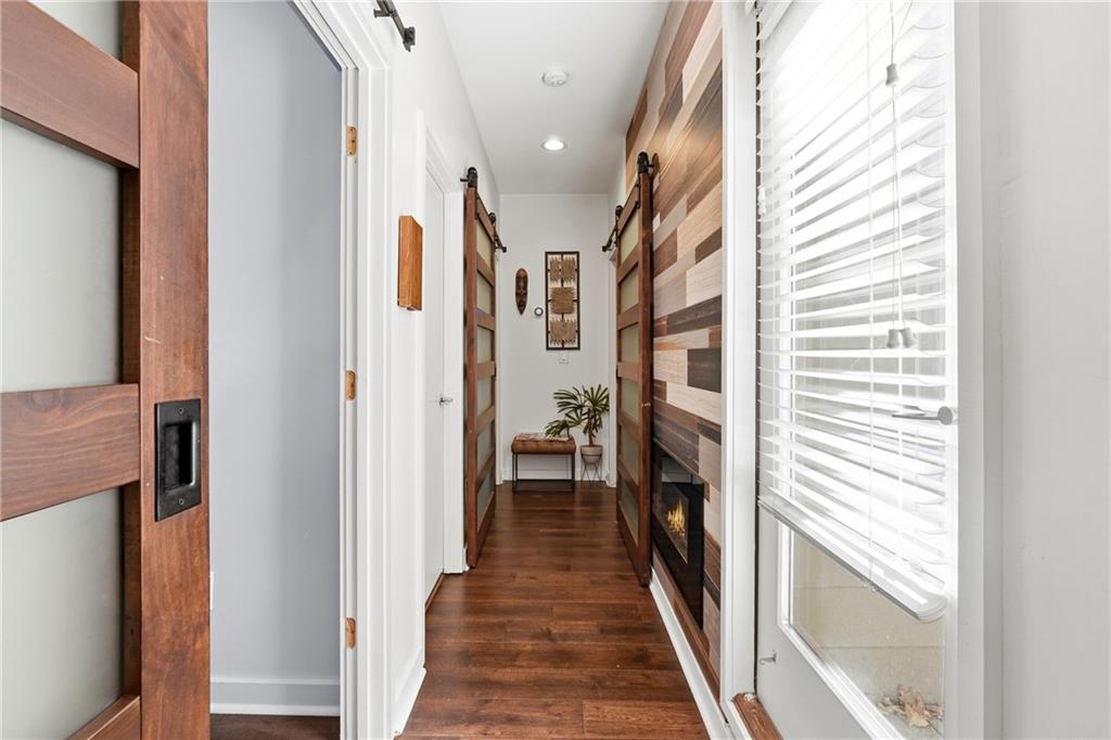 225 Crumley Street Southwest Atlanta, GA 30312 - Photo 3 of 23 a hallway with wooden floor and staircase