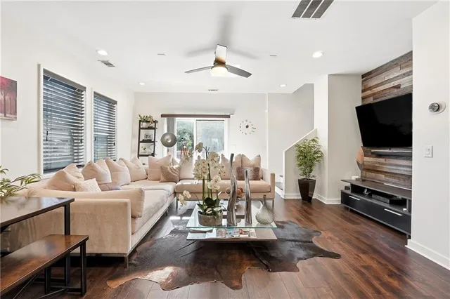 a living room with fireplace furniture and a flat screen tv