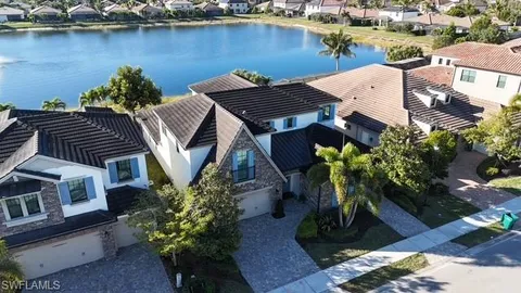 an aerial view of a house with garden space and lake view