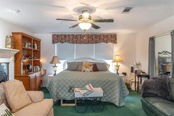a bedroom with a bed mirror and window