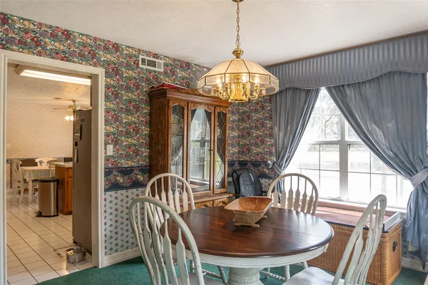 a view of a dining room with furniture wooden floor and chandelier