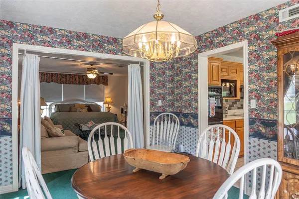 a view of a dining room with furniture wooden floor and chandelier