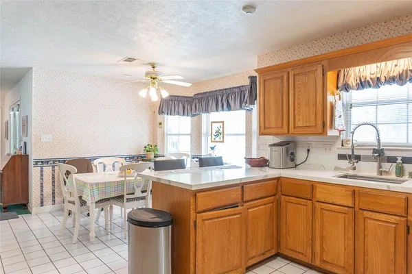a kitchen with a sink cabinets and window