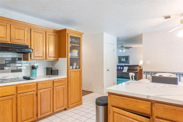 a kitchen with stainless steel appliances kitchen island granite countertop a sink cabinets and wooden floor