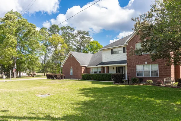 a front view of house with yard and green space