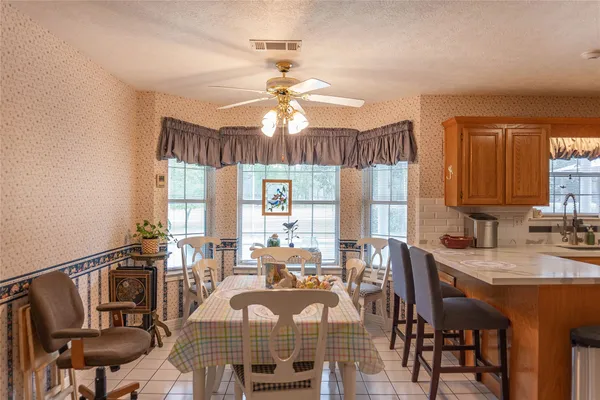 a view of a a dining room with furniture window and wooden floor