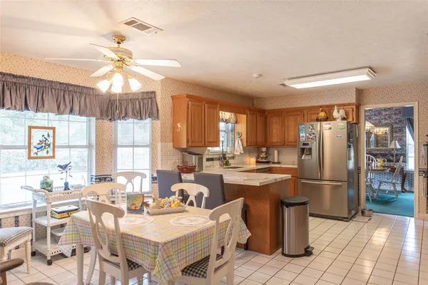 a very nice looking kitchen with a large window appliances and cabinets