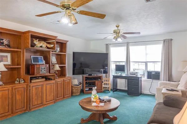 a living room with furniture a chandelier and a fireplace