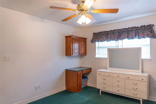 a room with a dresser and a window