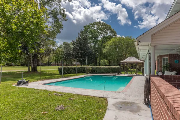 a view of a swimming pool with a patio