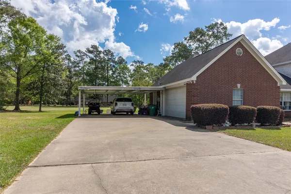 a view of a house with a yard and a patio