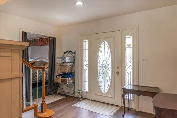 a view of a livingroom with wooden floor and a window