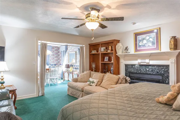 a bedroom with a bed couch and a fireplace
