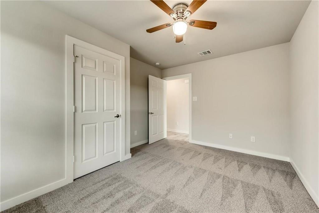 612 North 6th Gunter, TX 75058 - Photo 12 of 17 an empty room with a chandelier fan and windows