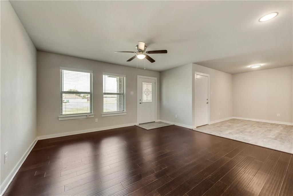 612 North 6th Gunter, TX 75058 - Photo 3 of 17 a view of an empty room with window and wooden floor