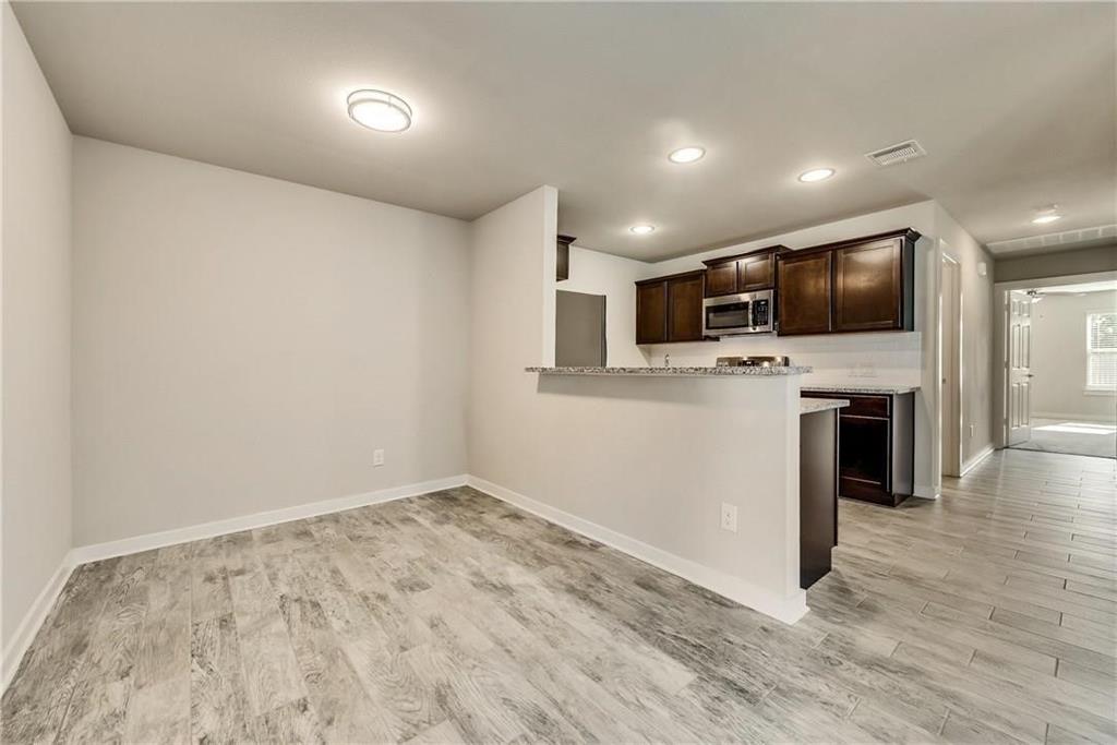 612 North 6th Gunter, TX 75058 - Photo 6 of 17 a view of a kitchen with a sink and a microwave