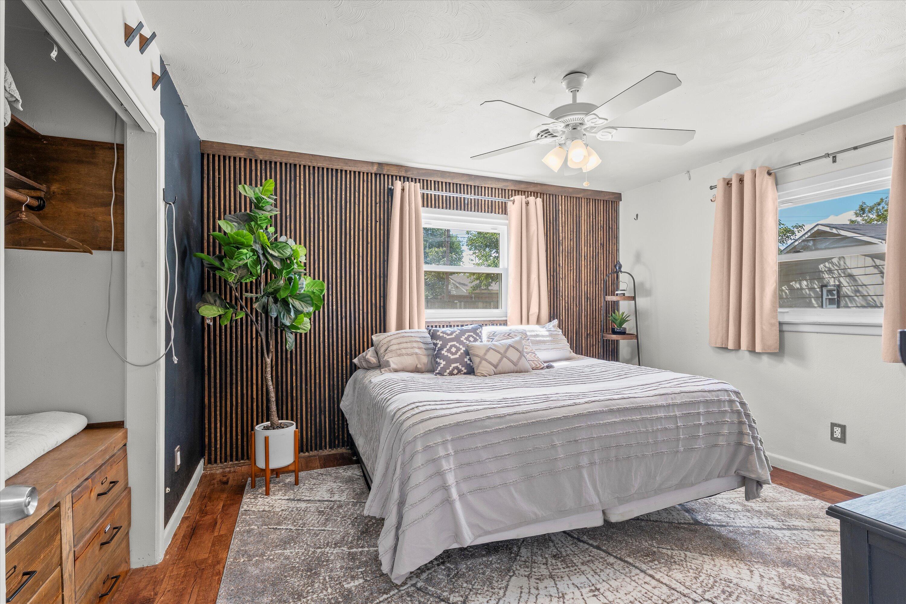 5305 13th Street Lubbock, TX 79416 - Photo 13 of 31 a bedroom with a bed and a potted plant