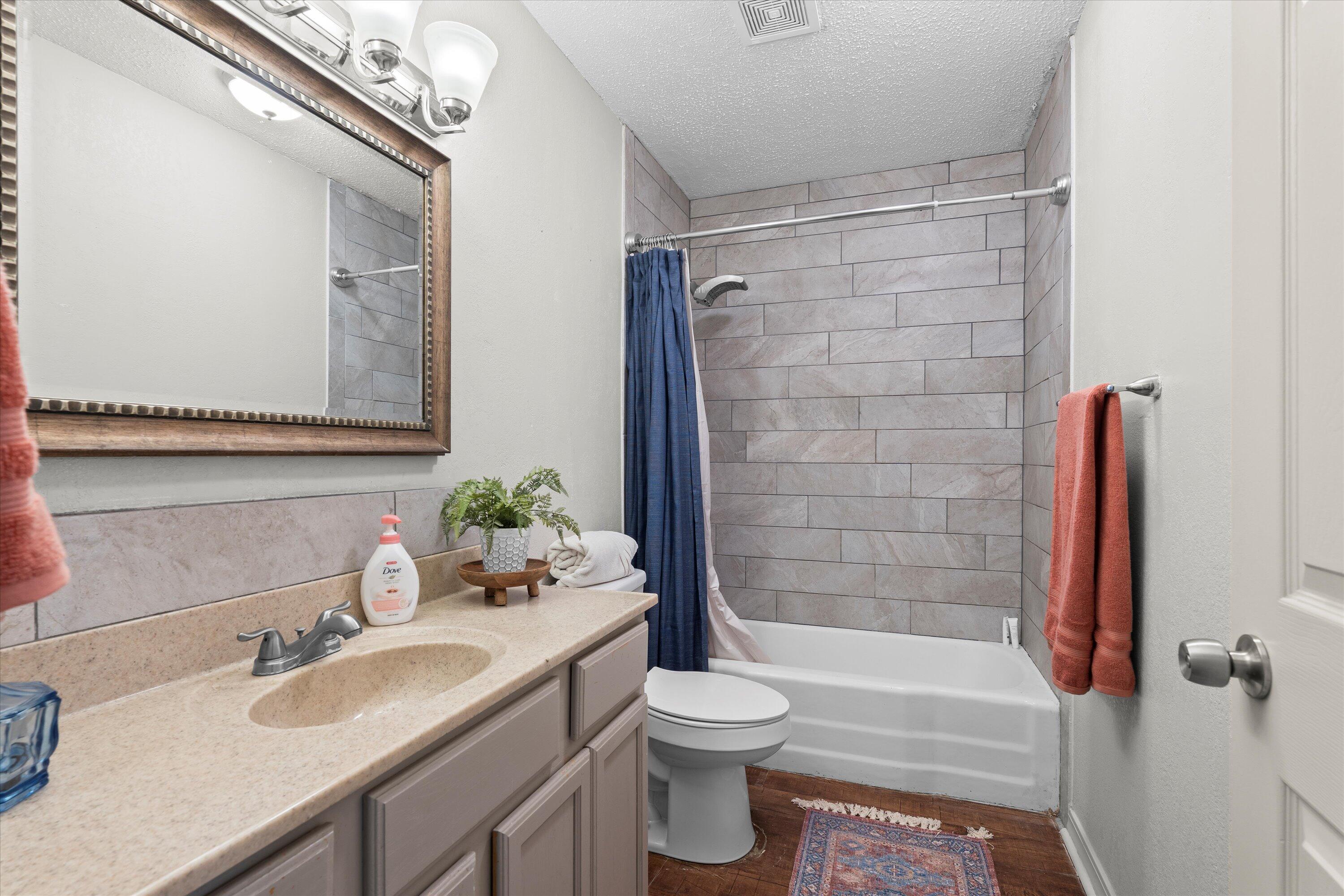 5305 13th Street Lubbock, TX 79416 - Photo 18 of 31 a bathroom with a sink a toilet and shower