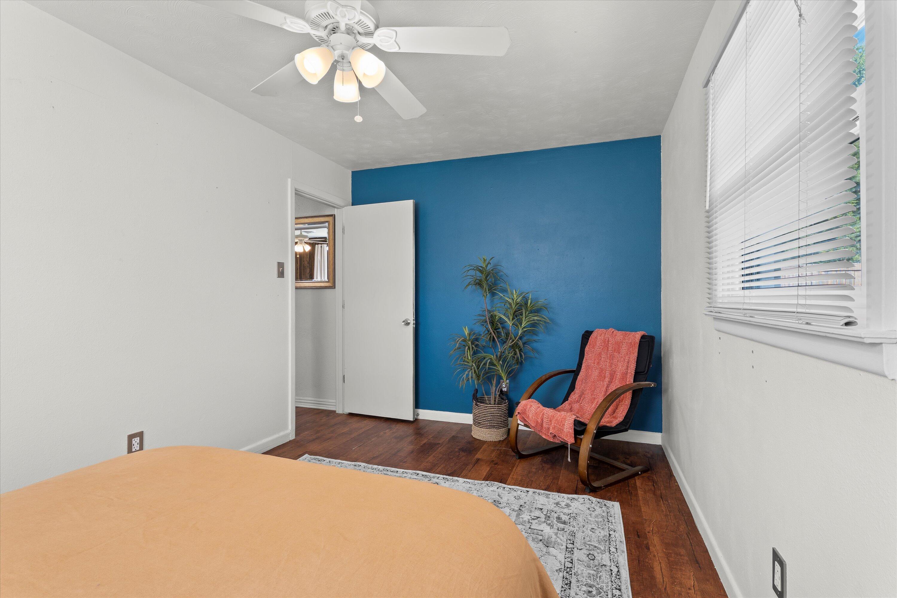 5305 13th Street Lubbock, TX 79416 - Photo 20 of 31 a bedroom with a bed and a chandelier
