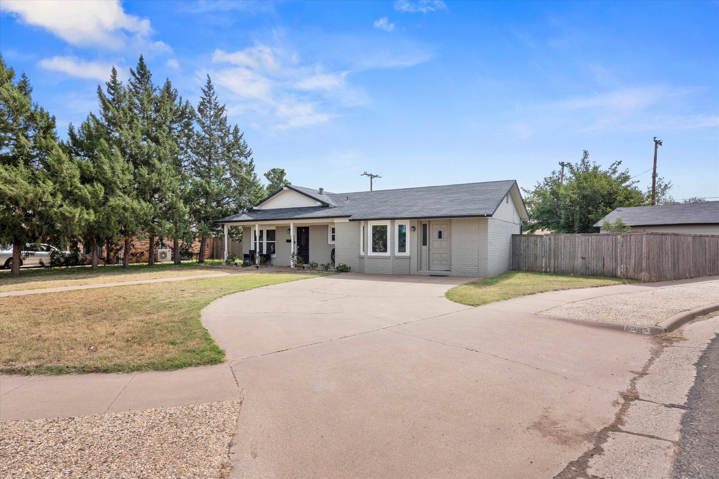 5305 13th Street Lubbock, TX 79416 - Photo 2 of 31 a front view of house with yard and green space