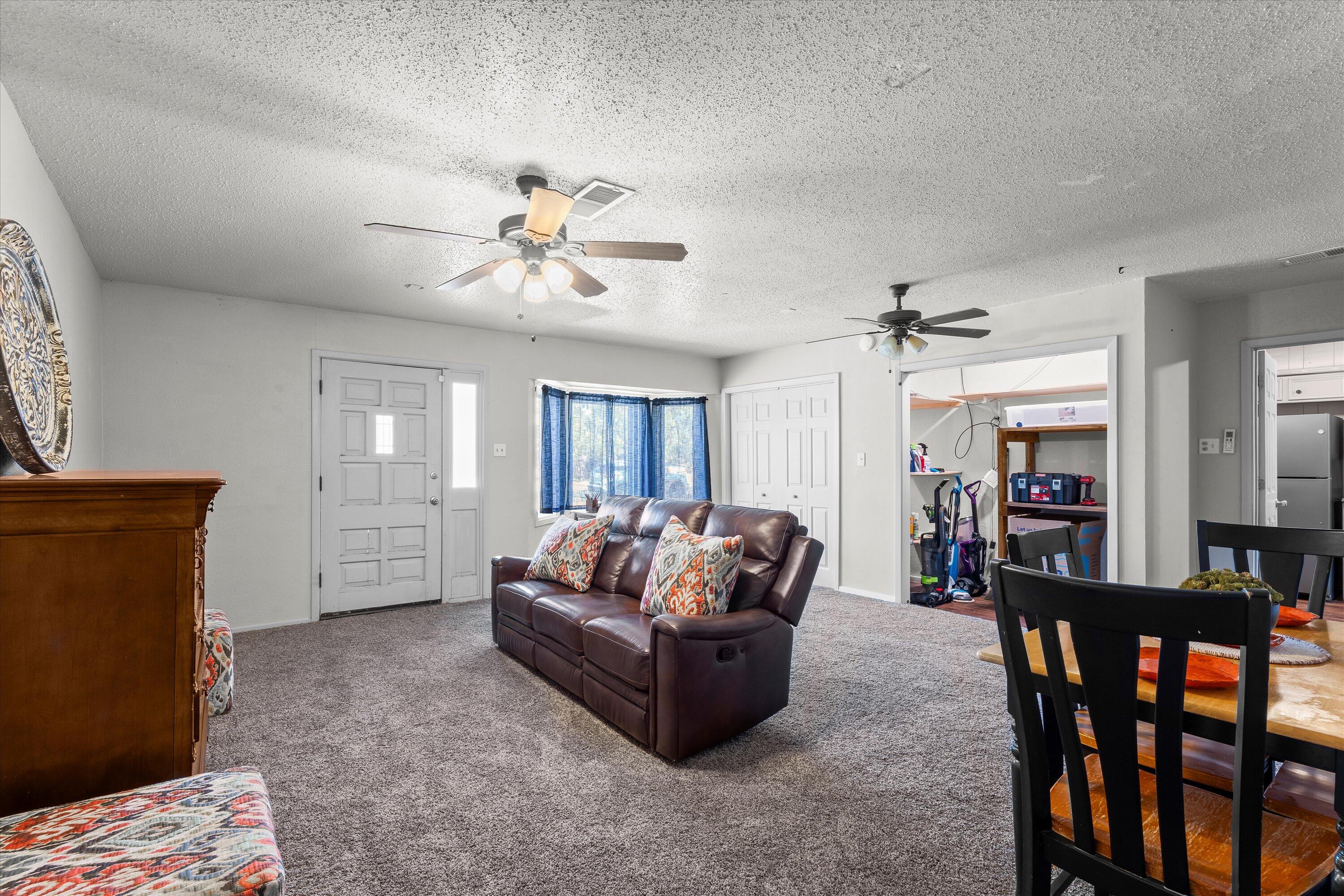 5305 13th Street Lubbock, TX 79416 - Photo 23 of 31 a living room with furniture ceiling fan and a window