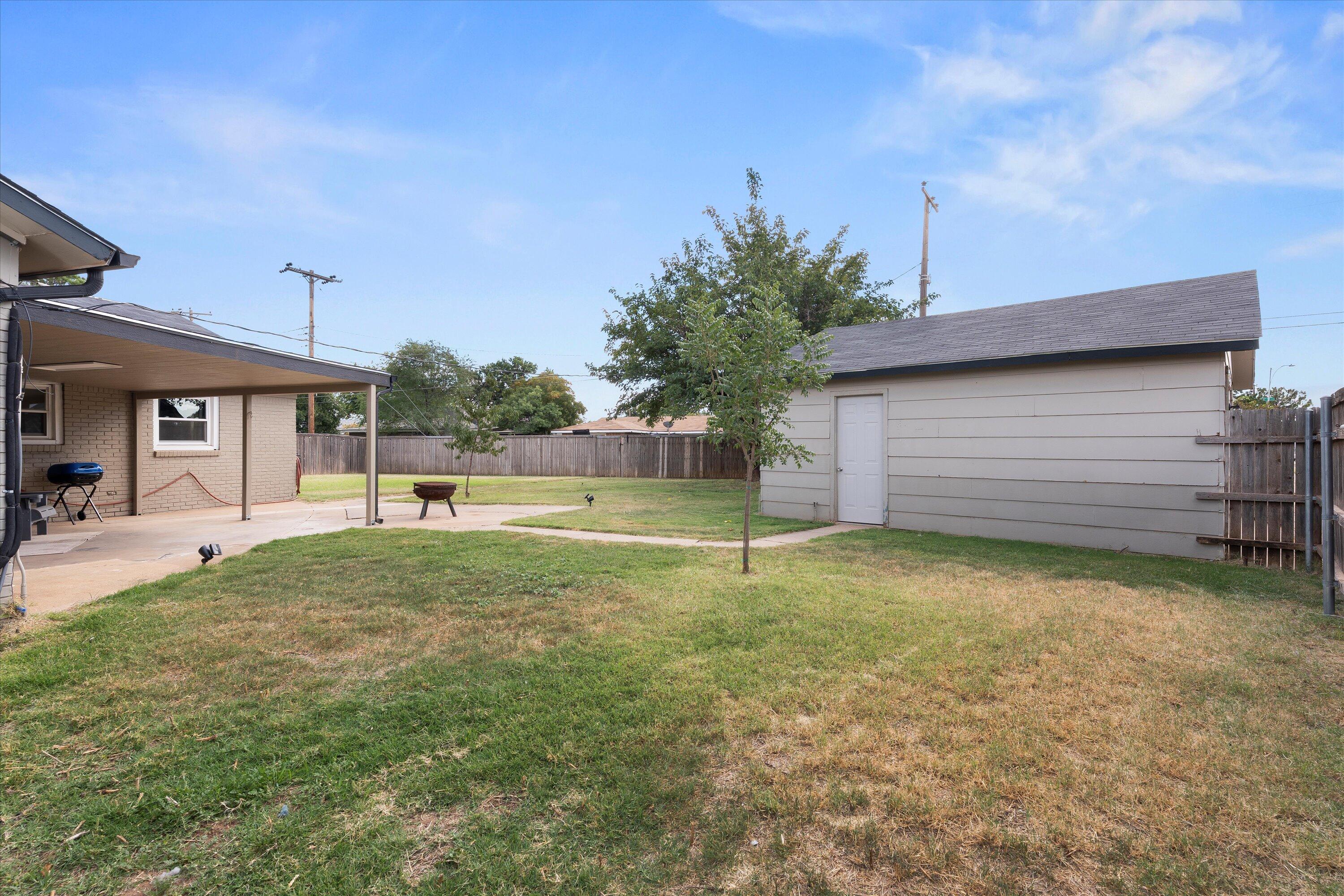 5305 13th Street Lubbock, TX 79416 - Photo 26 of 31 a view of backyard of house and car parked