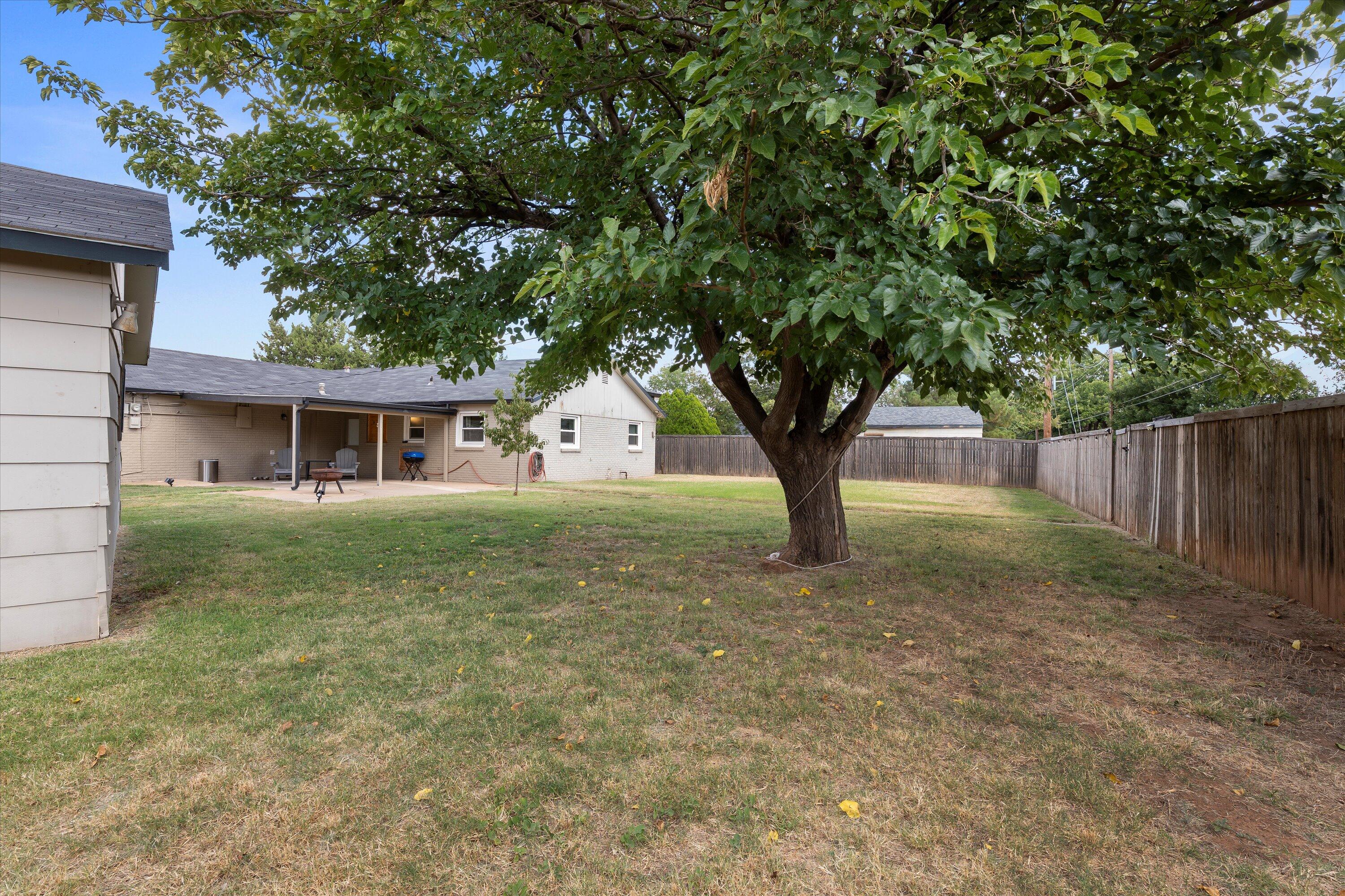 5305 13th Street Lubbock, TX 79416 - Photo 27 of 31 a house with trees in the background