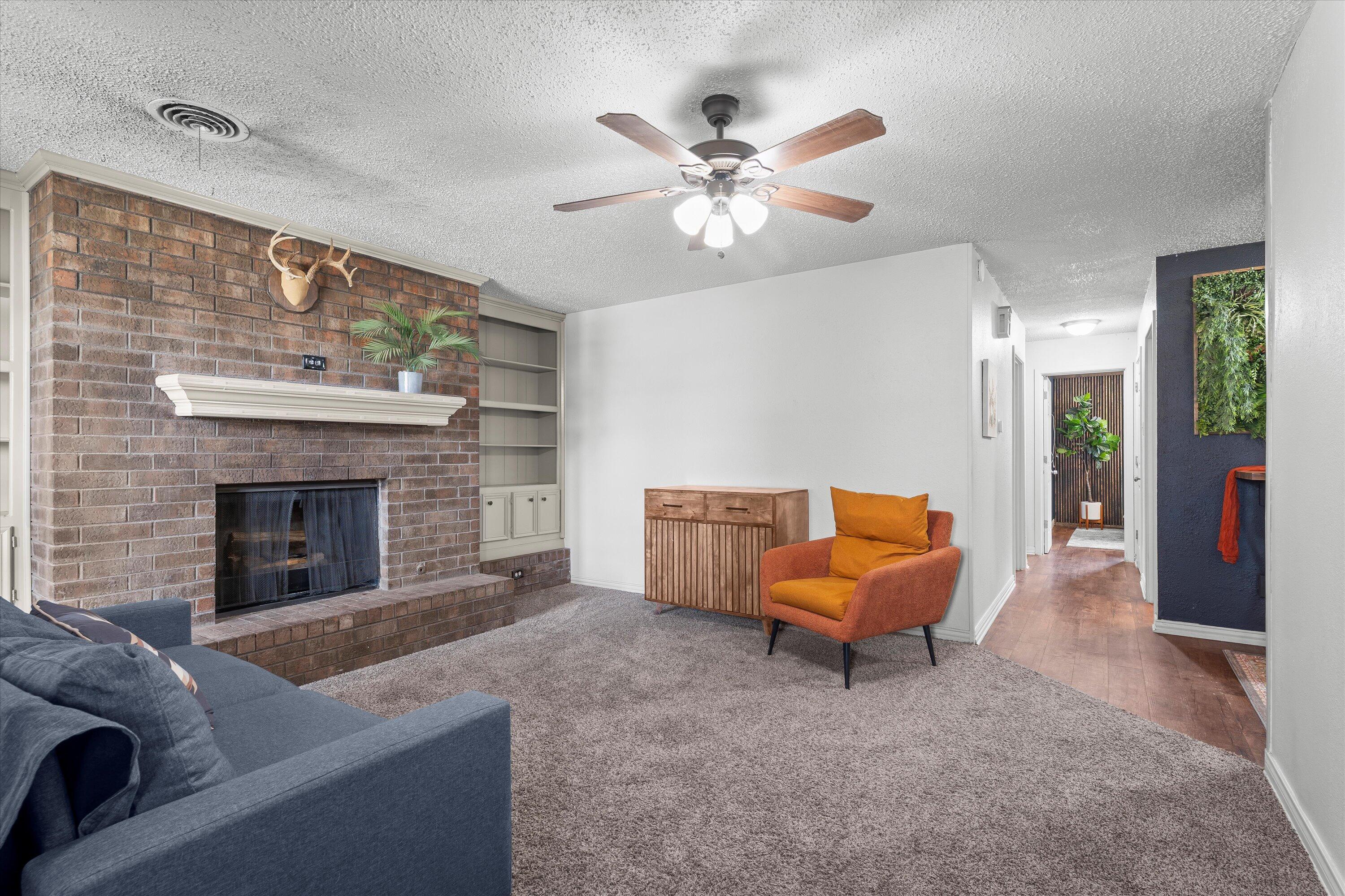 5305 13th Street Lubbock, TX 79416 - Photo 5 of 31 a living room with furniture and a fireplace