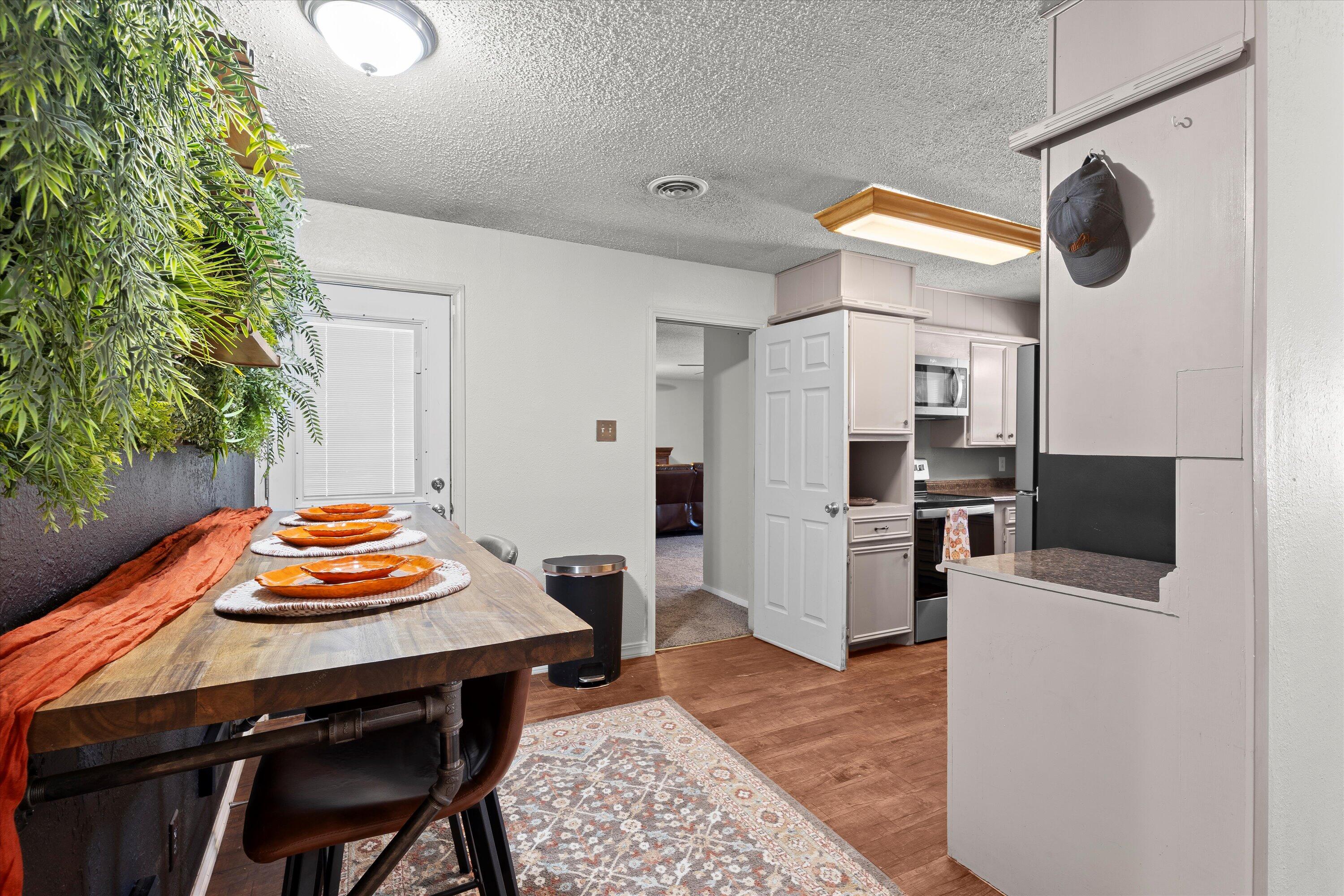 5305 13th Street Lubbock, TX 79416 - Photo 8 of 31 a kitchen with a table and chairs