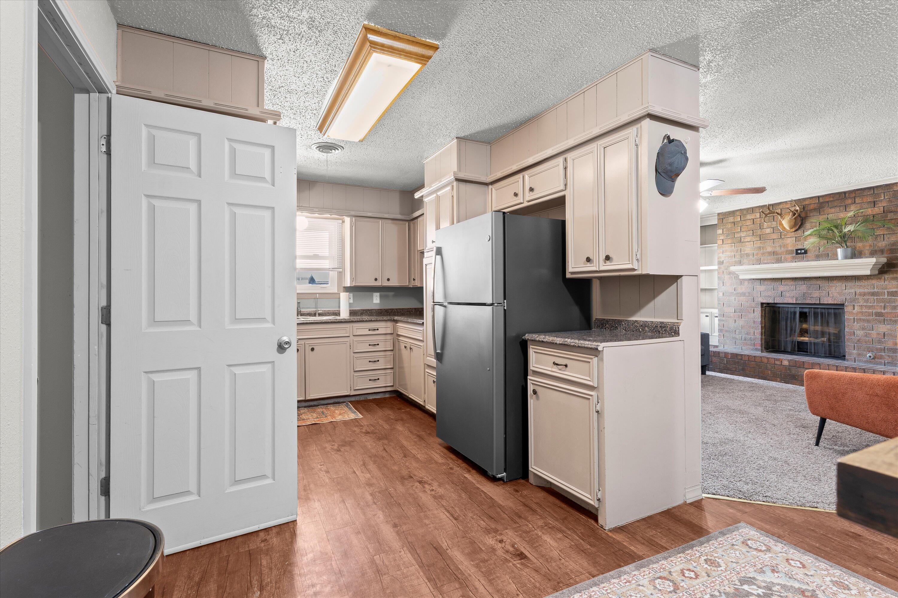 5305 13th Street Lubbock, TX 79416 - Photo 9 of 31 a kitchen with stainless steel appliances a refrigerator sink and cabinets