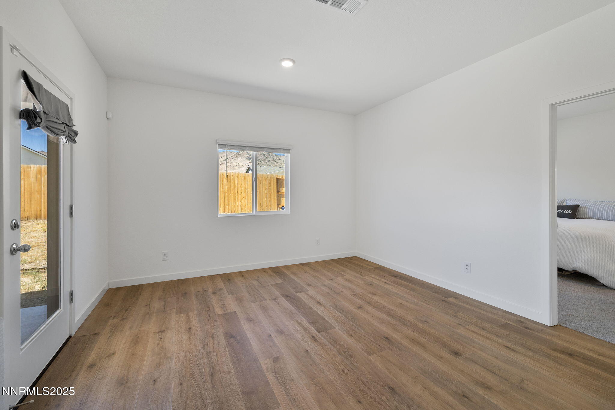 847 Schell Crk Drive Dayton, NV 89403 - Photo 12 of 31 a view of empty room with wooden floor and fan