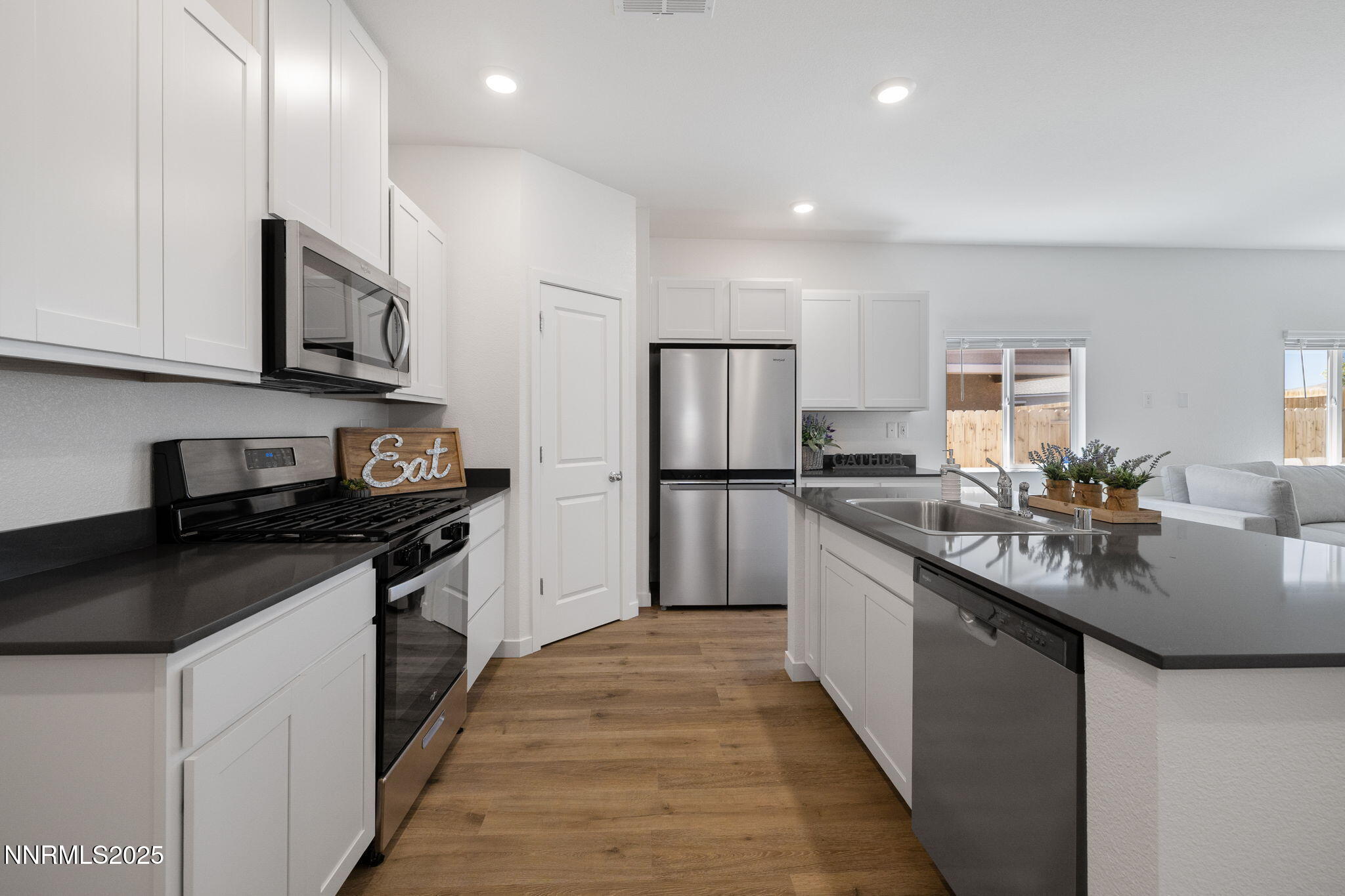 847 Schell Crk Drive Dayton, NV 89403 - Photo 5 of 31 a kitchen with stainless steel appliances granite countertop a sink a stove and a refrigerator