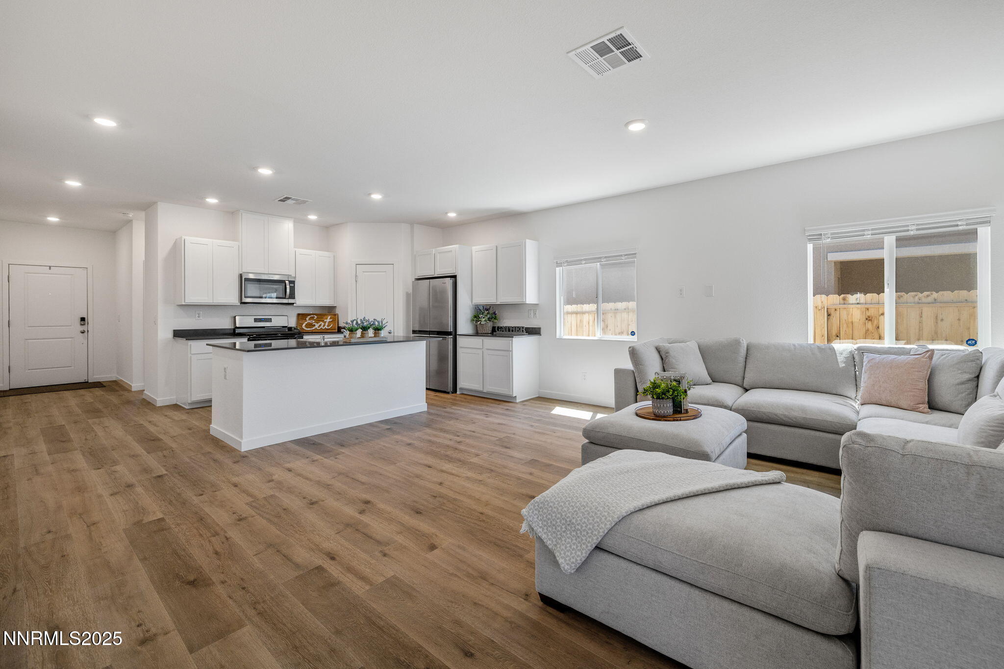 847 Schell Crk Drive Dayton, NV 89403 - Photo 9 of 31 a living room with kitchen island furniture and a wooden floor