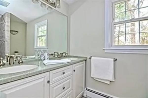 a bathroom with a granite countertop sink and a mirror