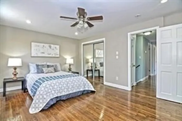 a bedroom with a large bed mirror and window