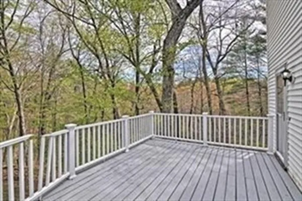 a view of balcony with wooden floor and fence