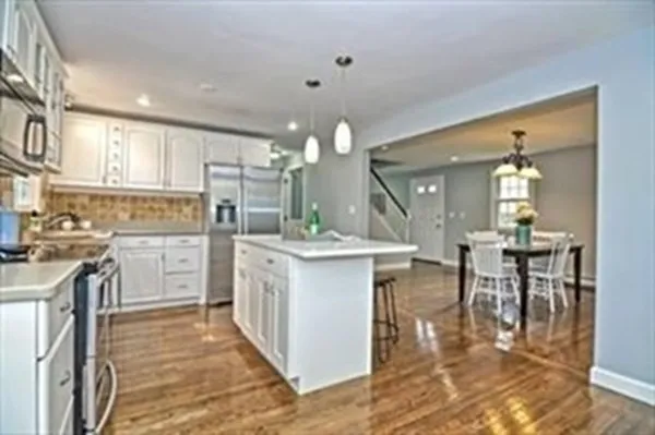 a kitchen with white cabinets and counter space