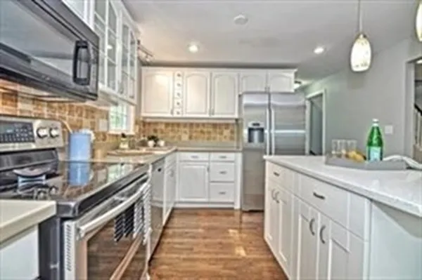a kitchen with cabinets and stainless steel appliances