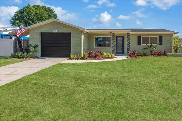a front view of a house with a yard and garage