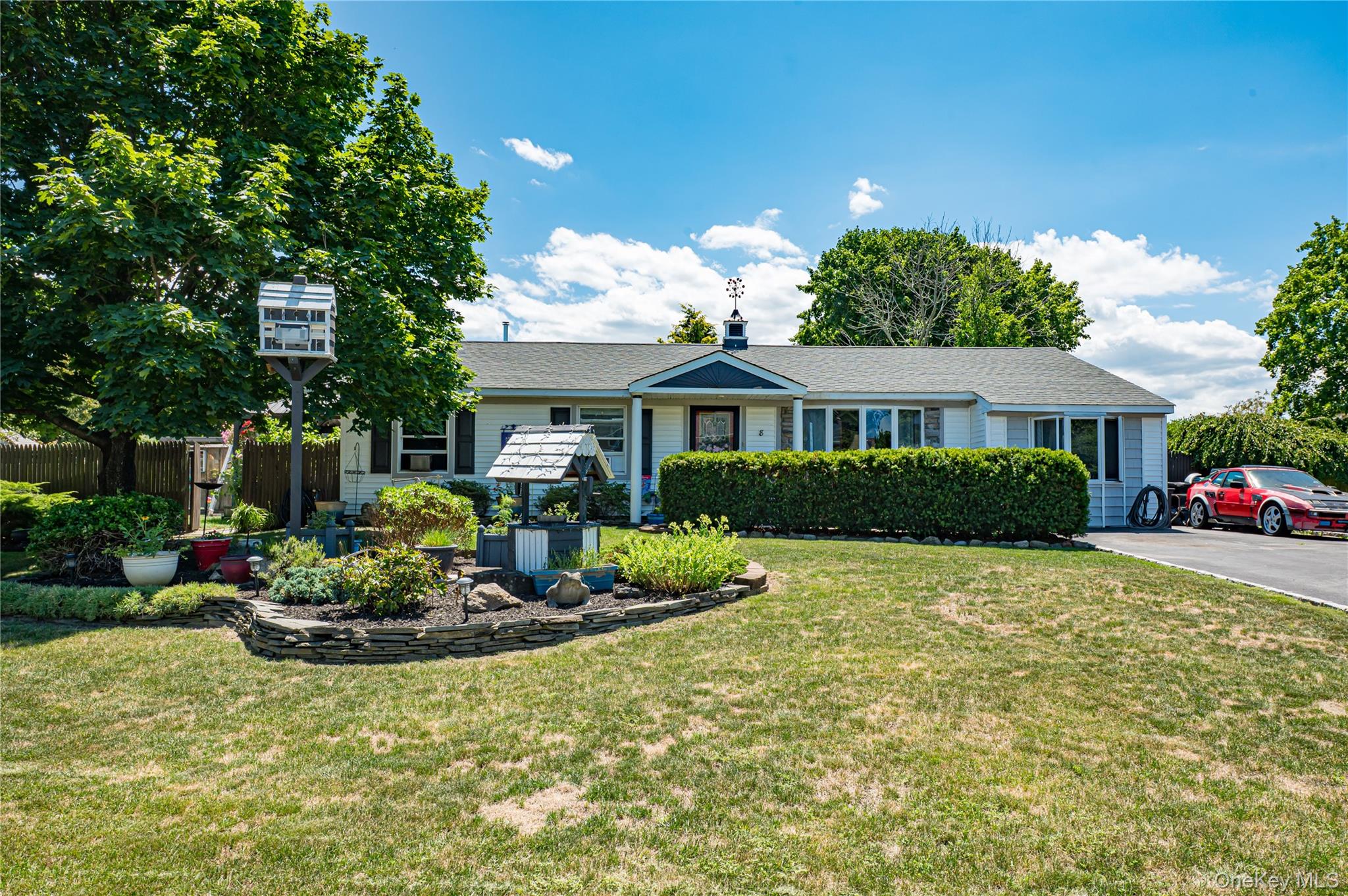 a front view of a house with a yard and outdoor seating