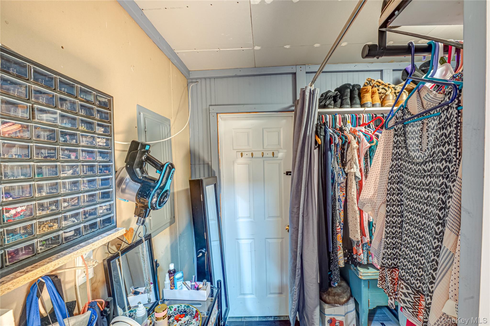 8 Woodbrook Drive, Unit 8 Ridge, NY 11961 - Photo 11 of 30 a view of walk in closet with clothes