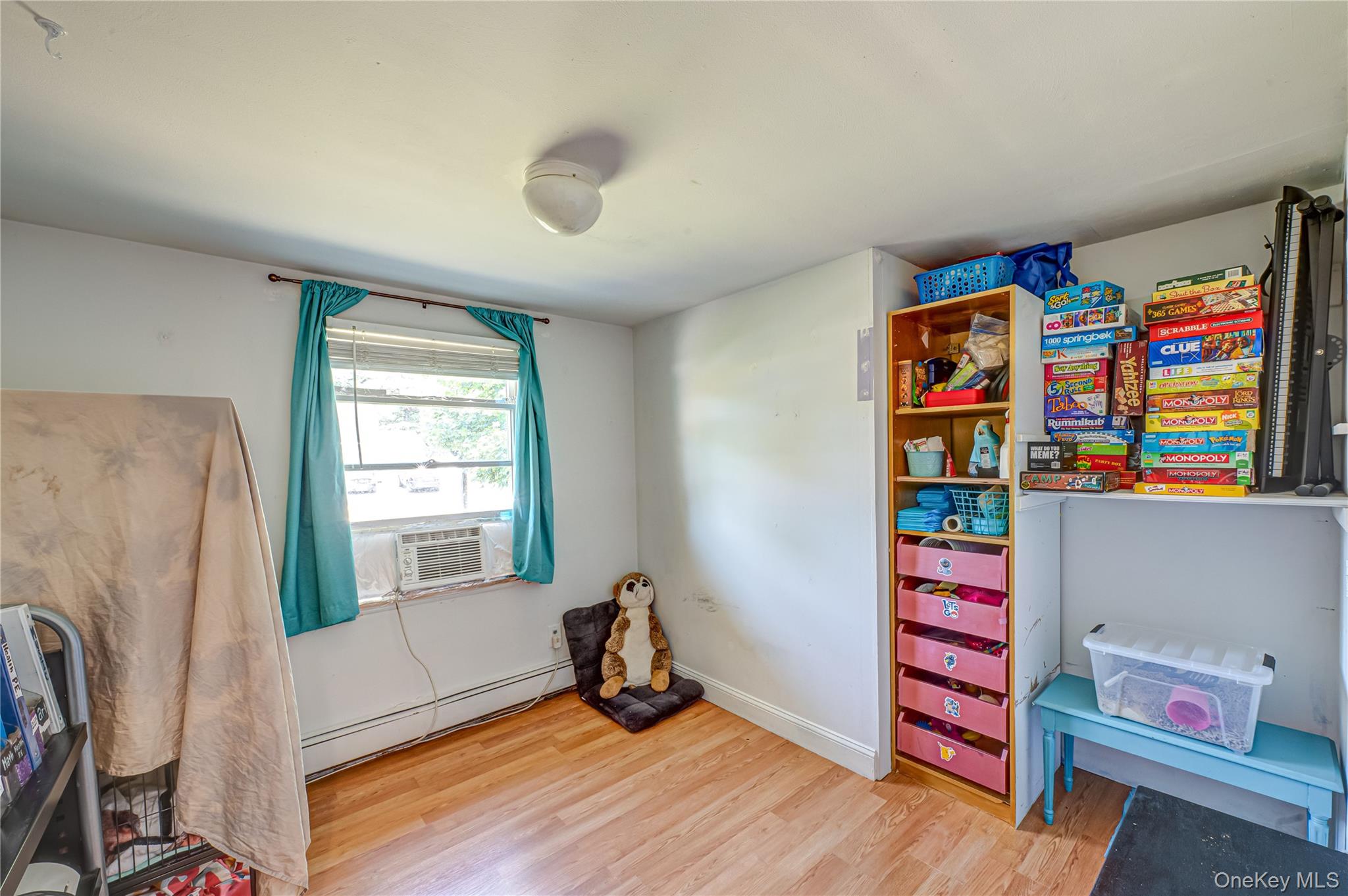 8 Woodbrook Drive, Unit 8 Ridge, NY 11961 - Photo 13 of 30 a room with furniture and a window