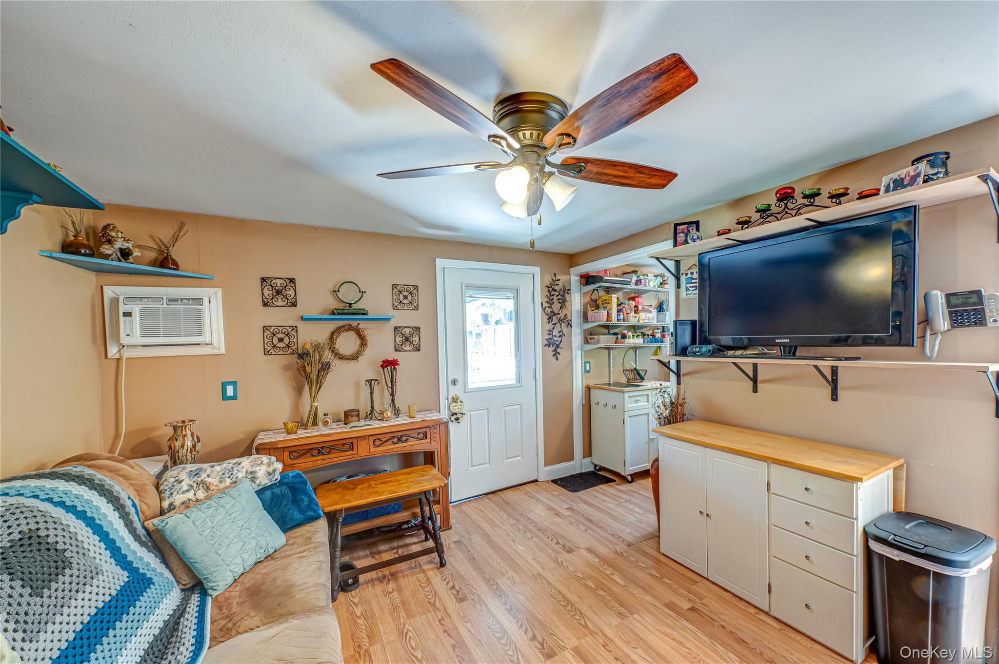 8 Woodbrook Drive, Unit 8 Ridge, NY 11961 - Photo 16 of 30 a living room with furniture and a flat screen tv