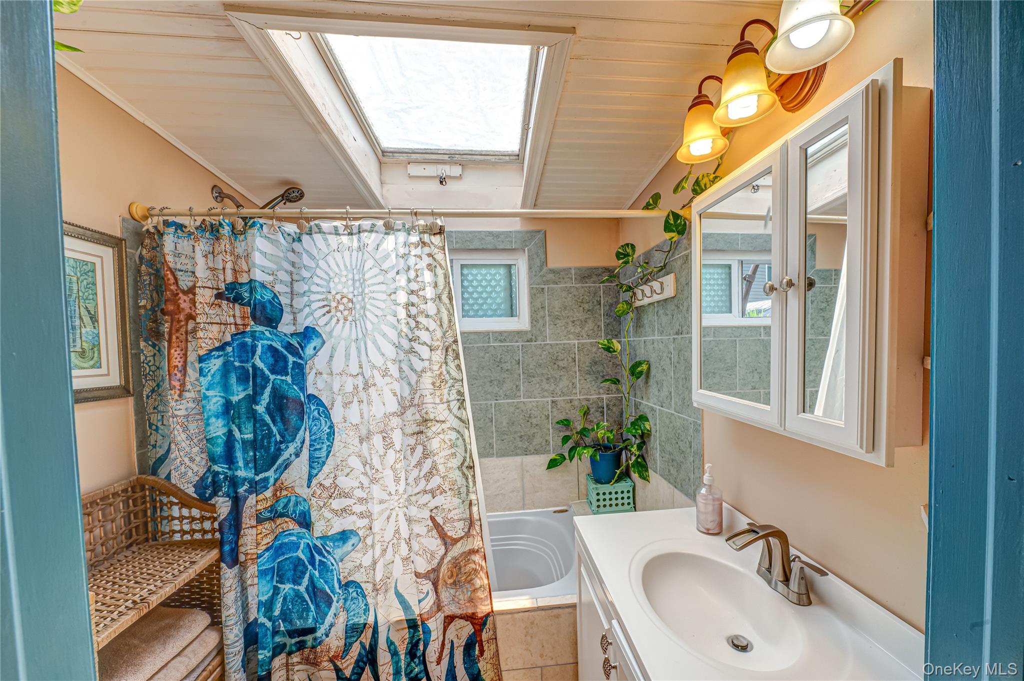 8 Woodbrook Drive, Unit 8 Ridge, NY 11961 - Photo 17 of 30 a bathroom with a sink and mirror with bathtub