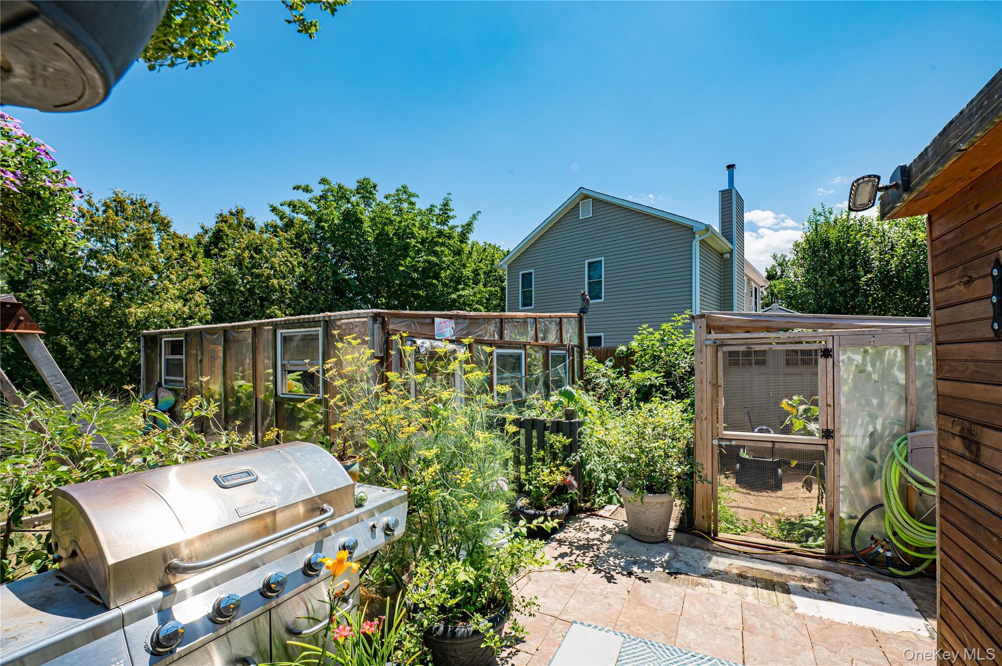 8 Woodbrook Drive, Unit 8 Ridge, NY 11961 - Photo 20 of 30 a view of a backyard with sitting area