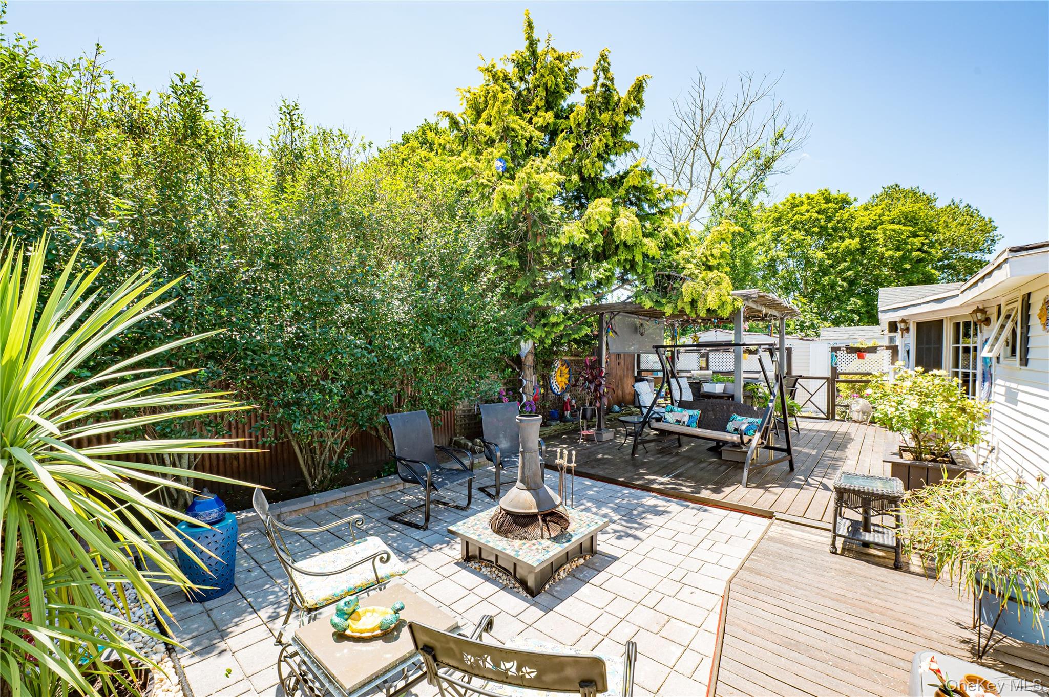8 Woodbrook Drive, Unit 8 Ridge, NY 11961 - Photo 22 of 30 a view of backyard of house with seating space