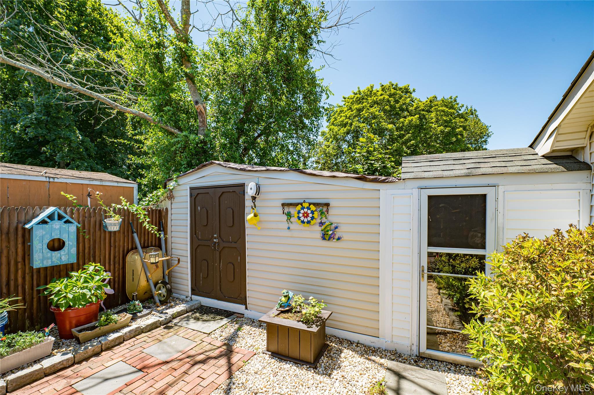 8 Woodbrook Drive, Unit 8 Ridge, NY 11961 - Photo 24 of 30 a front view of a house with potted plants