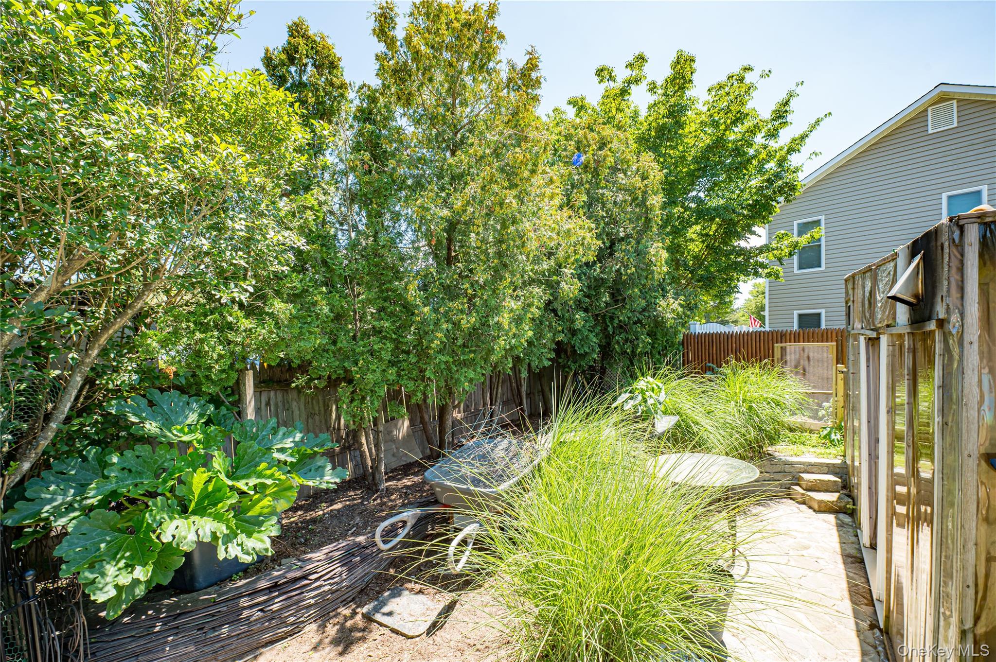 8 Woodbrook Drive, Unit 8 Ridge, NY 11961 - Photo 27 of 30 a backyard of a house with a yard and outdoor seating